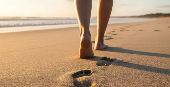 Bare feet walking on a sandy beach, symbolizing the So Easy mission to help rediscover natural rhythm one gentle step at a time