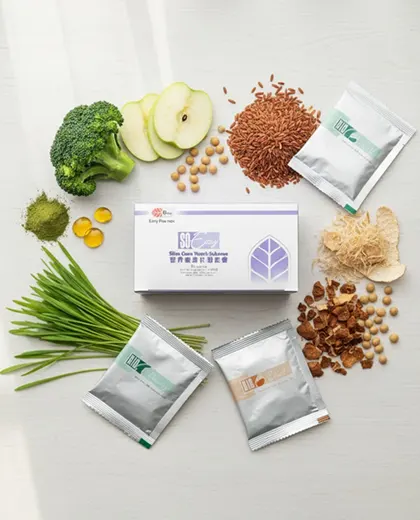 Flat lay of the So Easy 3-Day Cleanse kit surrounded by key synergistic ingredients: wheatgrass, oil palm fiber, red rice, and apples, emphasizing whole-plant nutrition